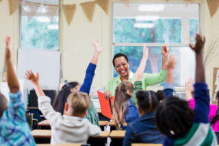 photo - Teacher Reading to School Children