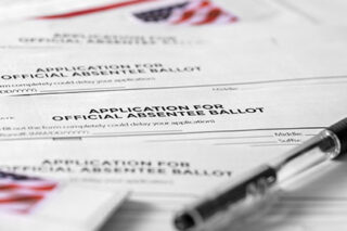 photo - Application for Absentee Ballot, Pen, and Stamps