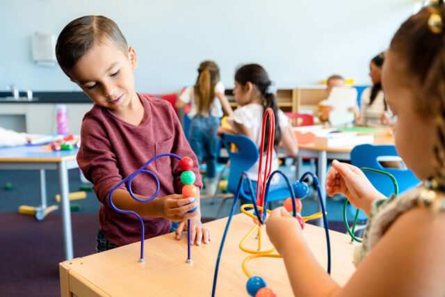 photo - boy playing with a toy at daycare