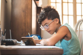 photo - Boy Using Mobile Phone for Online Learning from Home