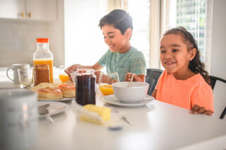 photo - Brother and Sister Eating Breakfast