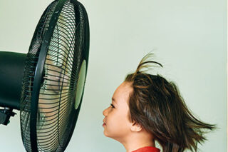 photo - Child in Front of Electric Fan