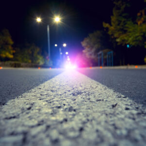 photo - City Road with Blurred Police Car Red and Blue Lights