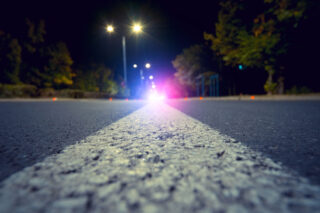 photo - City Road with Blurred Police Car Red and Blue Lights