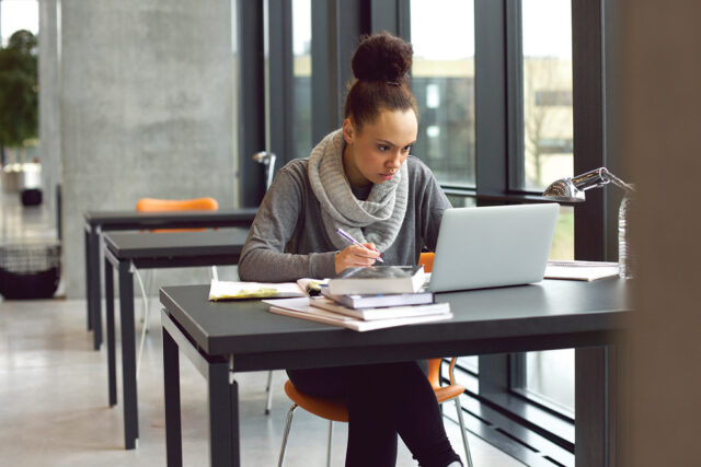 photo - College Student Working On Laptop