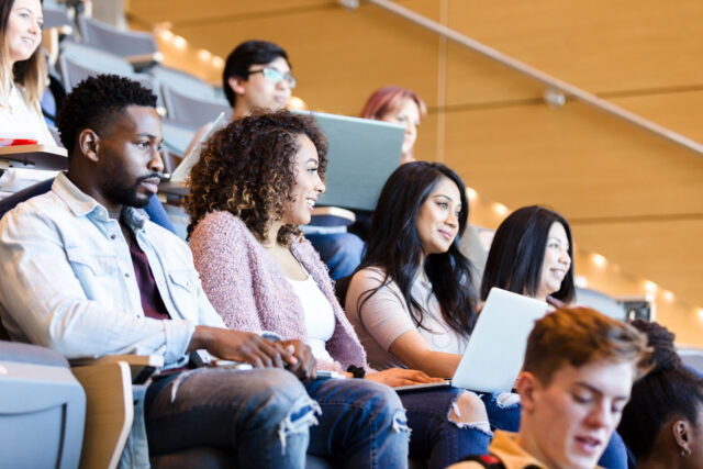 photo - College Students Sitting in Lecture Hall Ready for Class