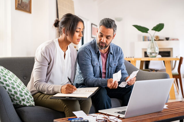 photo - a couple working on their taxes online