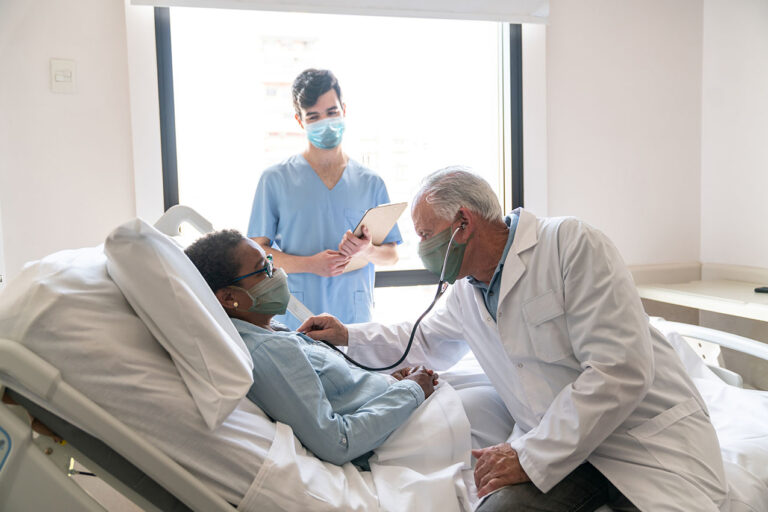 photo - Doctor Listening to Patient's Heart in Hospital