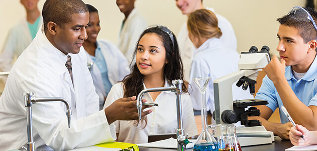 photo - High School Science Teacher Talking with Students in Chemistry Lab