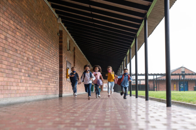 photo - Group of Kids Running at School and Wearing Facemasks