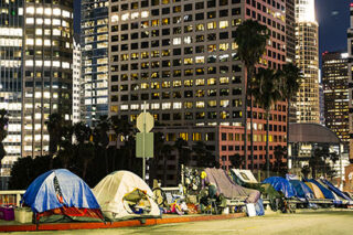 photo - Homelss Tents Beside Skyscrapers in Los Angeles Downtown at Night