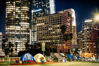 photo - Homeless Tents Beside Skyscrapers in Los Angeles Downtown at Night