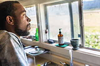 photo - Man at Kitchen Sink Looking Out Window