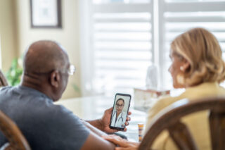 photo - Man on Mobile Phone for a Medical Video Appointment