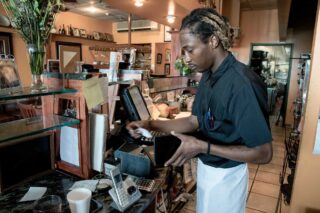 photo - Man Working Behind Counter at a Restaurant