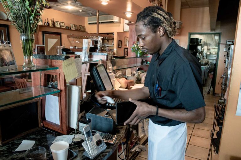 photo - Man Working Behind Counter at a Restaurant