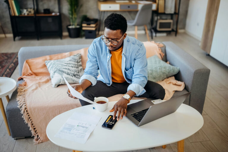 photo - Man Working on His Bills in His Living Room