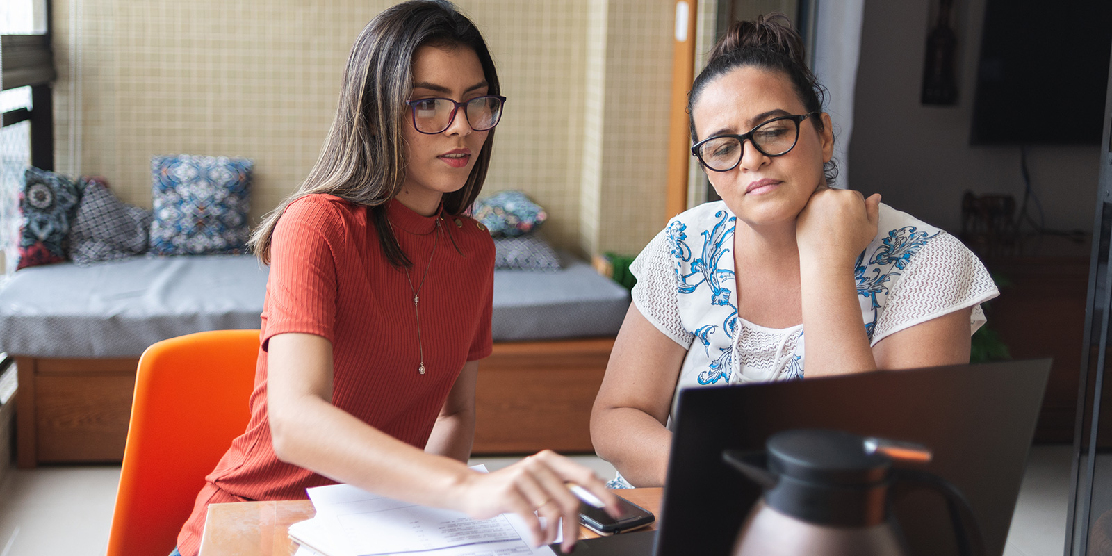 photo - Mother And Daughter Doing Finances Together At Home