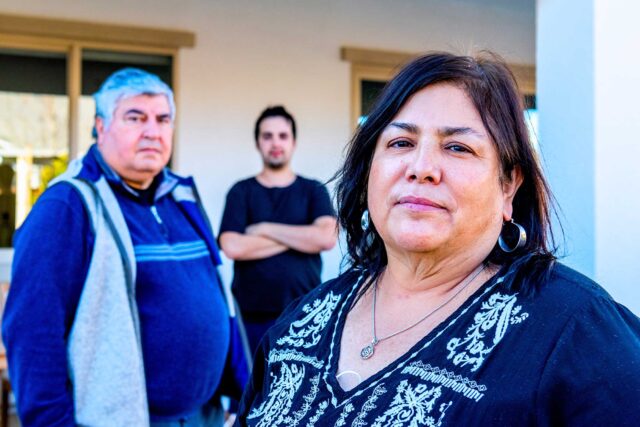 photo - Mother, Father, and Son Posing in Their Backyard