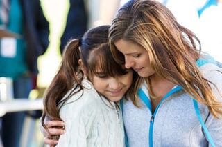 photo - Mother Giving Daughter a Hug