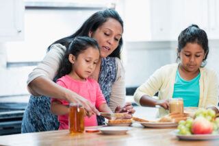 photo - Mother with daughters in the kitchen