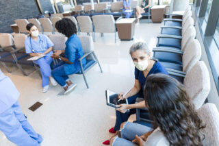 photo - Nurses Talking with Patients in Waiting Room