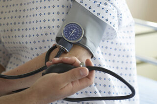 photo - Nurse Taking Patient's Blood Pressure