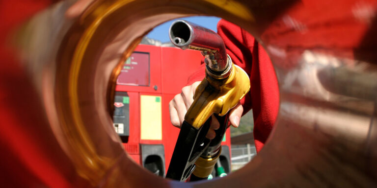 photo - Person Filling Up the Car in a Gas Station