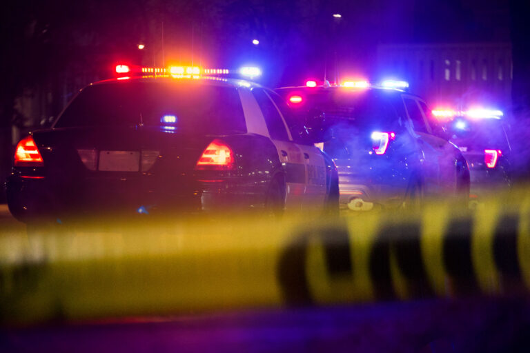 photo - Police Cars with Emergency Lights on, at Night