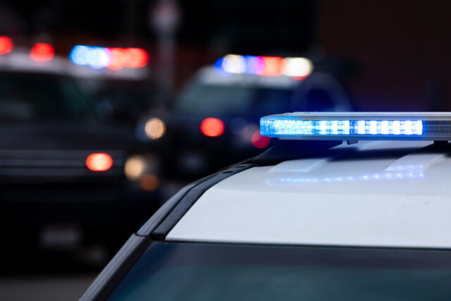 photo - Police Cars with Lights on at Night