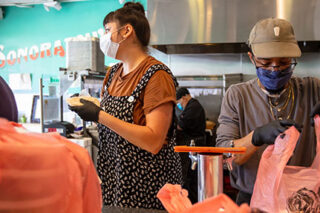 photo - Restaurant Staff Preparing To Go Orders and Wearing Masks