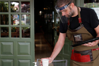 Photo of employee at a resturant cleaning