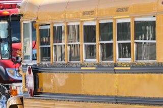 Photo of a School Bus Passing By A Firetruck