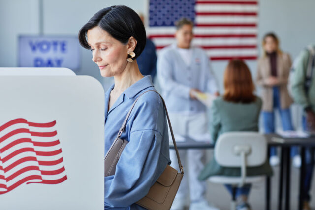 photo - Woman Voting in Booth