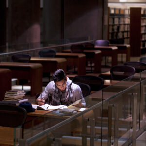 photo - Student Working in Library at Night