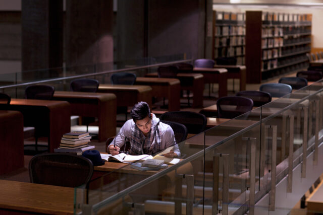 photo - Student Working in Library at Night