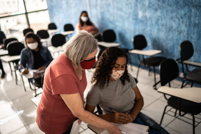 photo - Teacher Helping College Student