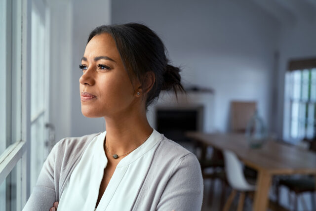 photo - Woman Looking Outside Window