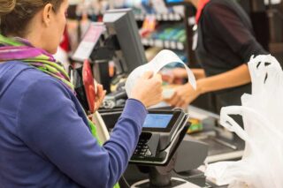 photo - Woman Paying for Groceries