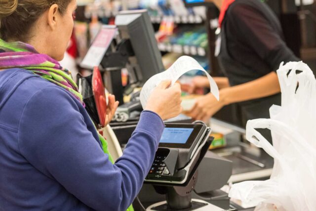 photo - Woman Paying for Groceries