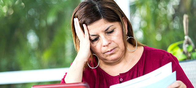 photo - Worried Woman Looking at Bills