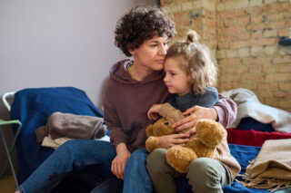 photo - Young woman with her child in a shelter